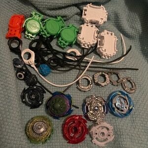 Beyblade Lot Launcher Rip Cord Spinner - There are a variety of pieces.